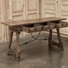 an old wooden desk with two open drawers