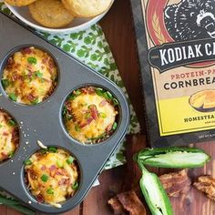 a muffin tin filled with breakfast food next to a box of kodiak cakes