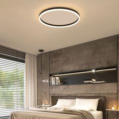 a bedroom with a bed, nightstands and lamps on the side of the wall