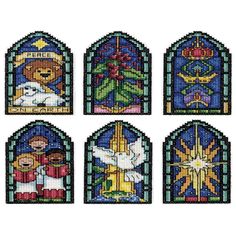 four different stained glass windows with animals and christmas decorations