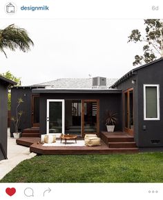 a modern house with an outdoor deck and patio