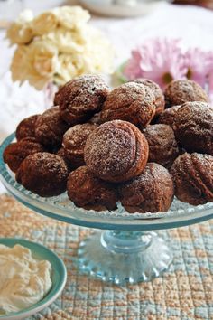 a glass bowl filled with powdered sugar cookies