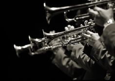 a man in a suit playing the trumpet