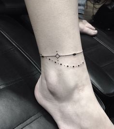 a woman's foot with a small star tattoo on the left side of her ankle