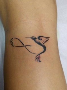 a tattoo on the arm of a woman with a bird flying over her head and an arrow