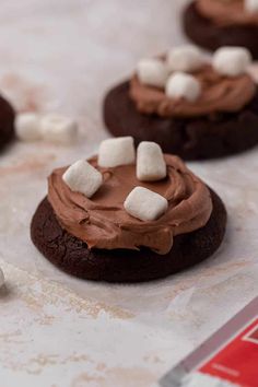 cookies with marshmallows and chocolate frosting on top