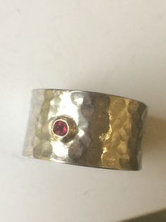 Silver Stamped Hand Made, Ring a faceted Rubelite Stone[2.60 mm] is set with Solid gold Bezel,stamped with an s inside,and 925. THE WIDTH of the Band is 11mm acrross,the gauge is 0.9 mm. tho smallish the gem has a lovely sparkle  .and can be worn plain band or turned round to show another side of ring. design can be made wider or narrower,or any size or gemstones mostly round or oval,Satin or high polish finish, this is the only piece i have made in this design,only on Etsy.thanks for viewing. Plain Bands, Red Band, Skull And Crossbones, Opal Rings, Stone Ring, Stone Rings, Silver Fashion, Band Rings, Tourmaline