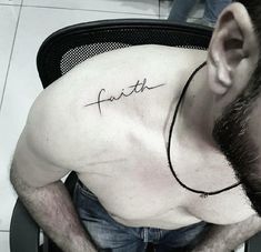 a man with a tattoo that reads faith on his chest