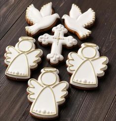 decorated cookies with white icing and gold trimmings on a wooden table top