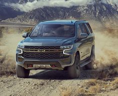 the new chevrolet colorado is driving on a dirt road