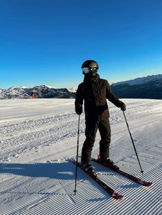 a man riding skis down a snow covered slope