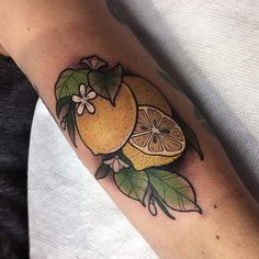 an orange with leaves and flowers on the arm