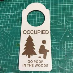 a door hanger that says occupied go poop in the woods