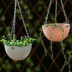 two hanging planters with green plants in them