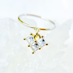 This 14k gold-filled heart ring is a dainty piece of everyday jewelry featuring cubic zirconia gemstones, perfect as a women's anniversary gift or a romantic gesture for your girlfriend. The delicate design makes it an ideal stackable promise ring, combining the elegance of a 14k gold-filled band with the sparkle of cubic zirconia, creating a versatile and meaningful accessory for various occasions. ✦  Elegant and Versatile: The Perfect Expression of Love and Commitment      *  14k gold filled ring with a heart-shaped charm adorned with four cubic zirconia stones      *  Available in sizes 4-8 with band options: 2mm textured, 2mm smooth, or 1mm thin      *  Suitable for everyday wear, special occasions, or as a promise, engagement, or stackable ring      *  Comes in a choice of blue, turqu