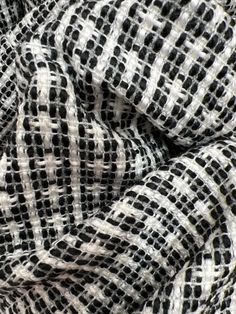 the black and white checkered fabric has been folded in an intricate pattern on it