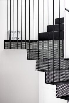 black and white staircase with metal handrails