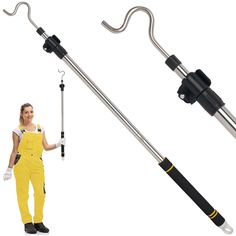 a woman in yellow overalls holding a black and silver umbrella pole with two handles