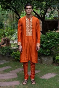 Shop for Deepthee Orange Silk Yoke Embroidered Kurta And Churidar Set for Men Online at Aza Fashions Bollywood Style Orange Traditional Wear With Intricate Embroidery, Orange Bollywood Traditional Wear With Intricate Embroidery, Orange Embroidered Sets For Festivals, Orange Embroidered Festival Sets, Semi-stitched Orange Raw Silk Kurta, Orange Raw Silk Kurta For Designer Wear, Designer Orange Raw Silk Kurta, Silk Traditional Wear With Dori Work In Orange, Orange Raw Silk Kurta For Diwali