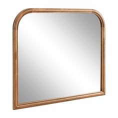 a wooden frame mirror on a white wall with a light brown wood trim around the edge