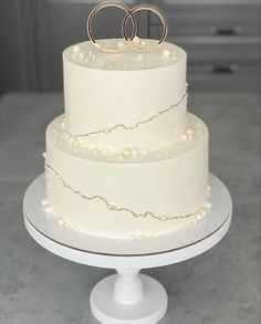 a wedding cake with two rings on top