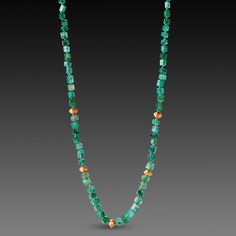 A lovely strand of uncut, polished emerald crystals in gradually shifting shades of green are strung together with a five, handmade 22k beads in this stunning necklace. Strand measures approximately 26 inches and is finished with 14k gold lobster clasp. Matte finish. This piece will be made to order, and will ship within 10-14 business days. If you need it sooner, use the Notes section on the order form to request a rush. Gold Emerald Bead Necklaces, Gold Emerald Round Bead Necklaces, Gold Emerald Necklace With Rondelle Gemstone Beads, Gold Emerald Necklaces With Gemstone Beads, Gold Emerald Necklace With Green Onyx Round Beads, Gold Necklace With Green Onyx Gemstone Beads, Green Onyx Necklace With Faceted Beads, Gold Single Strand Emerald Necklace, Gold Emerald Necklace With Round Beads Single Strand