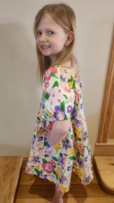 How fun is the puff sleeve?! This cloth material dress had small colorful flowers on it with a detail of buttons on the front! Fit: True to size Small: 7/8 Medium: 9/10 Large: 11/12 Extra large: 13/14 Laundry: wash on cold, low tumble, hang to dry The model is wearing a small. Material Dress, Cloth Material, Colorful Flowers, 9 And 10, Puff Sleeve, Extra Large, 10 Things, Flowers, How To Wear