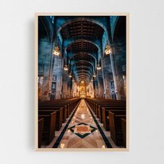 the interior of a church with pews and stained glass windows, framed in black frame