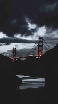 the golden gate bridge is lit up at night