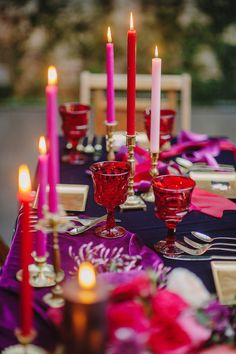 the table is set with candles and place settings