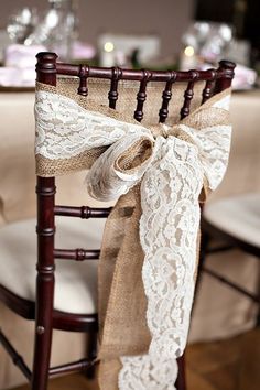 a chair decorated with burlock and lace for a rustic wedding or special event