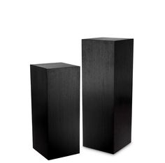 two tall black boxes sitting next to each other