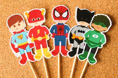 some cupcake toppers with superheros on them