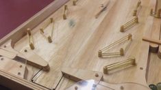 a close up of a wooden table with many pieces of wood and metal tools on it