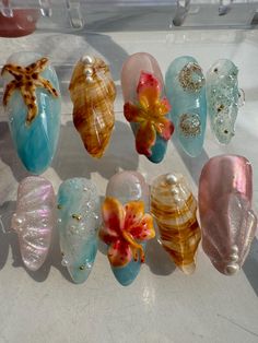 About this item: Dive into the Tropics: Our medium almond press-on nails are your ticket to a tropical paradise! Adorned with ocean-inspired elements like starfish, seashells, and vibrant tropical flowers, these nails are perfect for capturing that summer vibe all year round. Easy, Breezy, Beachy: These nails are not only reusable and lightweight, but they're also super easy to apply, giving you a salon-quality manicure in minutes. Whether you're dreaming of the beach or just want to add a splas Tropical Flower Design Nails, Ocean Inspo Nails, Summer Nails Charms, Cute Nails Beach, Hawai’i Nails, Ocean Waves Nails, Tropical Theme Nails, Under The Sea Nail Designs, 3d Beach Nails