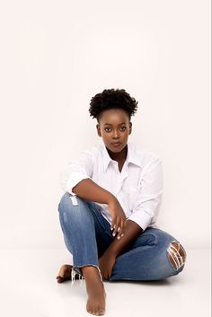 a woman sitting on the ground with her legs crossed