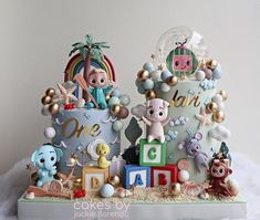 there is a cake decorated with animals and letters