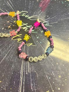 a close up of a bracelet on a table with words spelled out in small letters