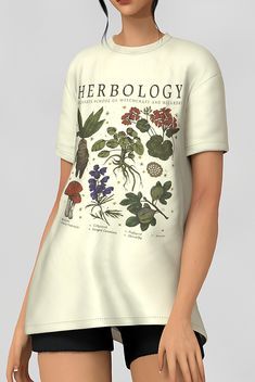 a woman wearing a t - shirt with flowers and plants printed on the front in white