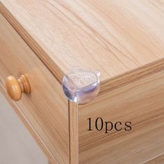 a close up of a drawer with some glass knobs on the top and bottom