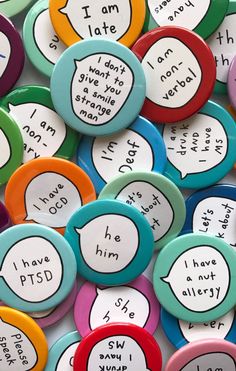 many different colored buttons with words on them