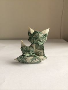 an origami cat made out of dollar bills