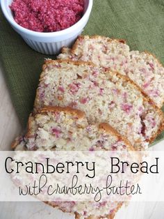 cranberry bread with cranberries - butter is cut into slices and sits on a green cloth