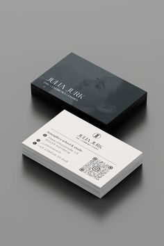 a black and white business card sitting on top of a table