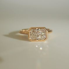 a diamond ring sitting on top of a table