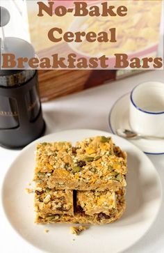 no - bake cereal breakfast bars on a plate next to a cup and saucer