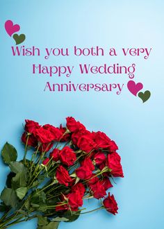 a bouquet of red roses sitting on top of a blue table next to a card that says, wish you both a very happy wedding anniversary