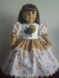 the doll is wearing a dress with a turkey on it