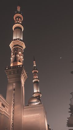 the top of a building with two minalis on it's sides at night