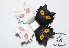 three black and white cats with yellow eyes are on a white surface, one is made out of leather